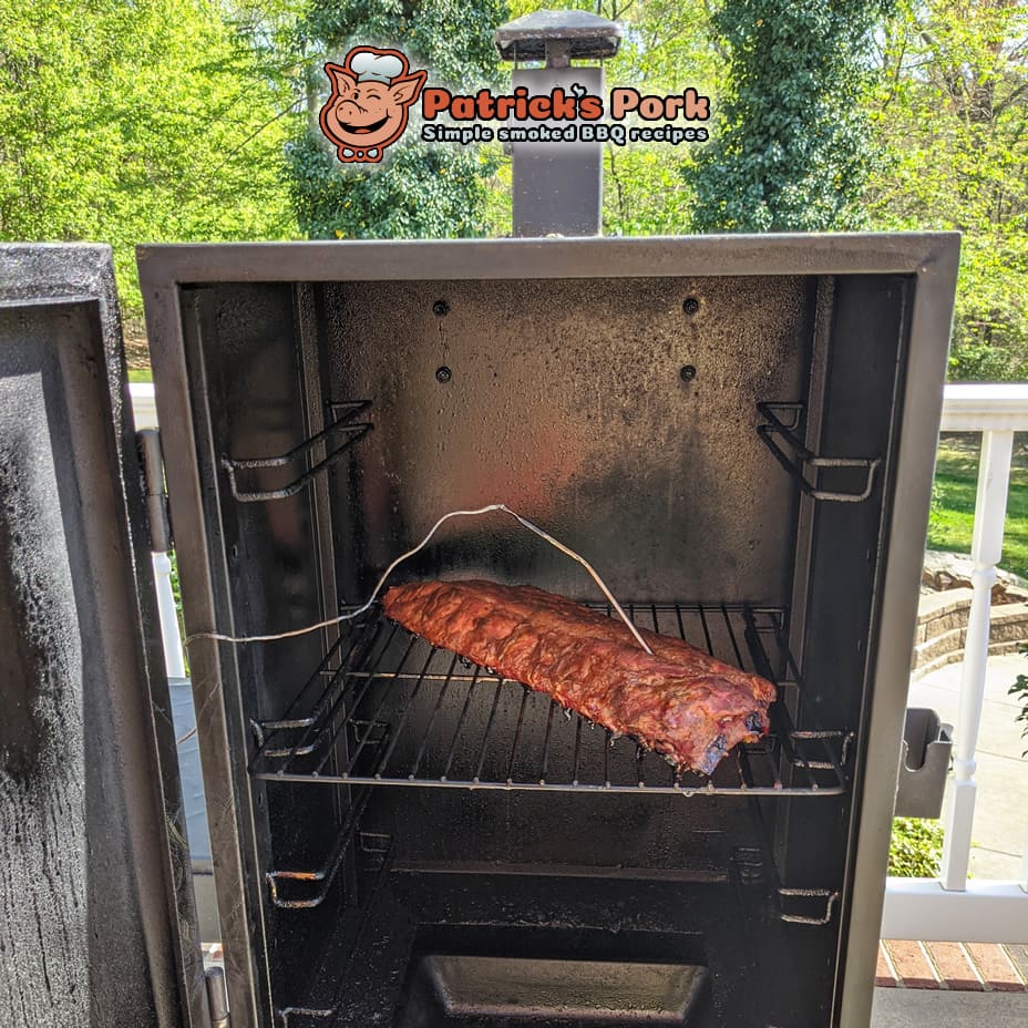 Pork ribs in smoker with temperature probe